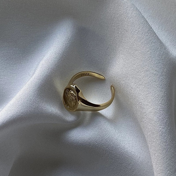 Gold portrait ring on fabric