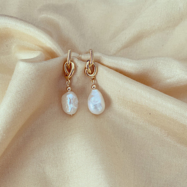 9ct Gold Knot Pearl Drop Earrings on fabric