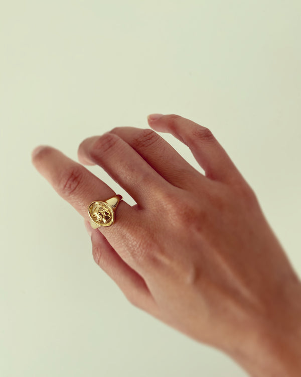 Gold portrait ring on hand