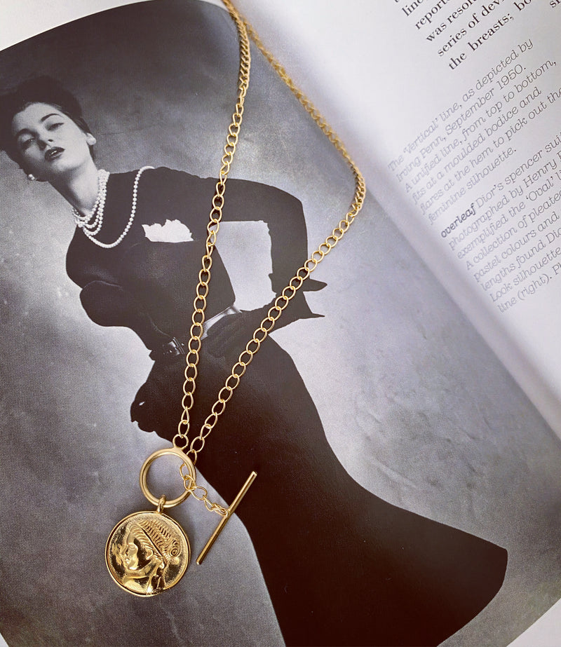 18ct Gold Roman Empress necklace on book page image