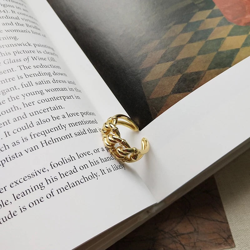 Gold chains ring on book background